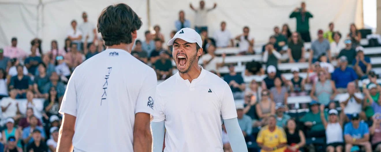 Ben Johns yells out in victory to partner Gabe Tardio after a grueling five game match win